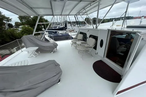 Slide: The Image of Spacious deck of 2001 Crosswater Passagemaker 49 yacht with seating and covered area. - 27