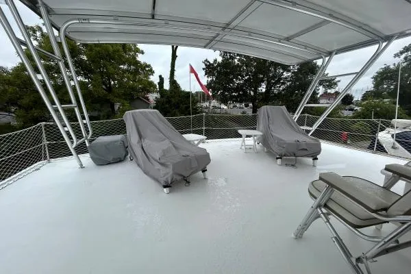 Slide: The Image of Upper deck of 2001 Crosswater Passagemaker 49 with covered lounge chairs. - 28