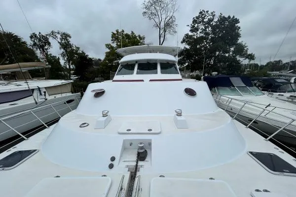 Slide: The Image of 2001 Crosswater Passagemaker 49 yacht docked, showcasing sleek design and spacious deck. - 33