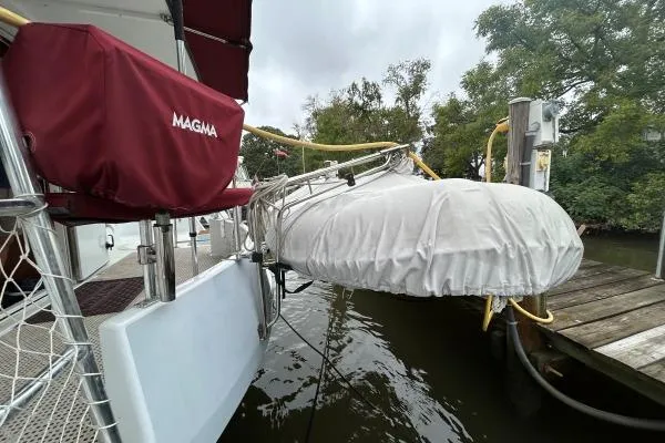 Slide: The Image of 2001 Crosswater Passagemaker 49 docked with covered equipment and trees in the background. - 36