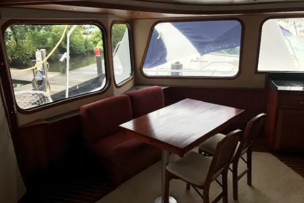 Slide: The Image of Interior of 2001 Crosswater Passagemaker 49 yacht with dining area and large windows. - 4