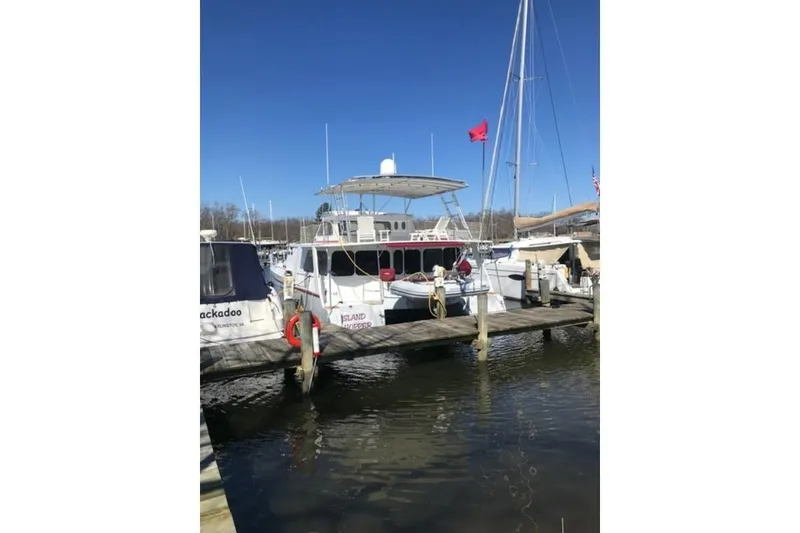 Slide: The Image of Crosswater Passagemaker 49 yacht docked at marina, 2001 model, clear blue sky. - 40