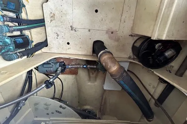 Slide: The Image of Engine room of 2001 Crosswater Passagemaker 49 with visible hoses and fittings. - 54