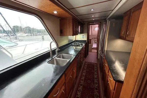 Slide: The Image of Luxurious 2001 Crosswater Passagemaker 49 yacht kitchen with sleek countertops and ample cabinetry. - 6