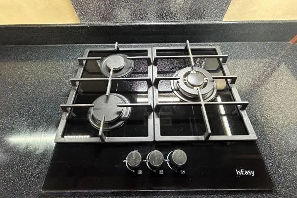 Slide: The Image of Modern black four-burner gas stove on sleek countertop, IsEasy brand. - 8