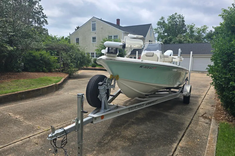 Slide: The Image of 2023 Key West 188 Bay Reef boat on trailer in residential driveway. - 11