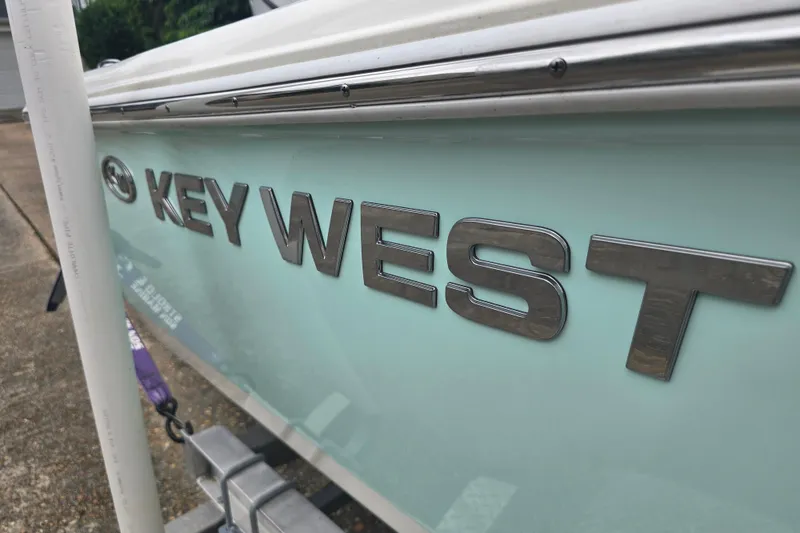 Slide: The Image of 2023 Key West 188 Bay Reef boat, close-up of logo on light blue hull. - 12