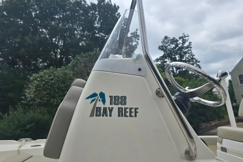Slide: The Image of 2023 Key West 188 Bay Reef boat console with steering wheel, outdoors. - 13