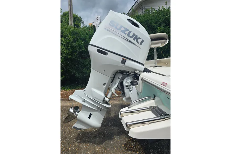 Slide: The Image of 2023 Key West 188 Bay Reef boat with Suzuki outboard motor, docked outdoors. - 14