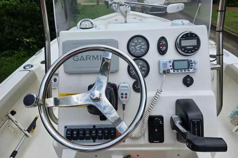 Slide: The Image of 2023 Key West 188 Bay Reef boat dashboard with steering wheel and navigation instruments. - 16