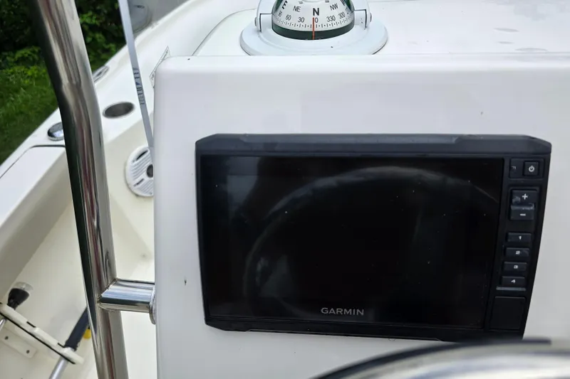 Slide: The Image of 2023 Key West 188 Bay Reef boat dashboard with Garmin display and compass. - 17