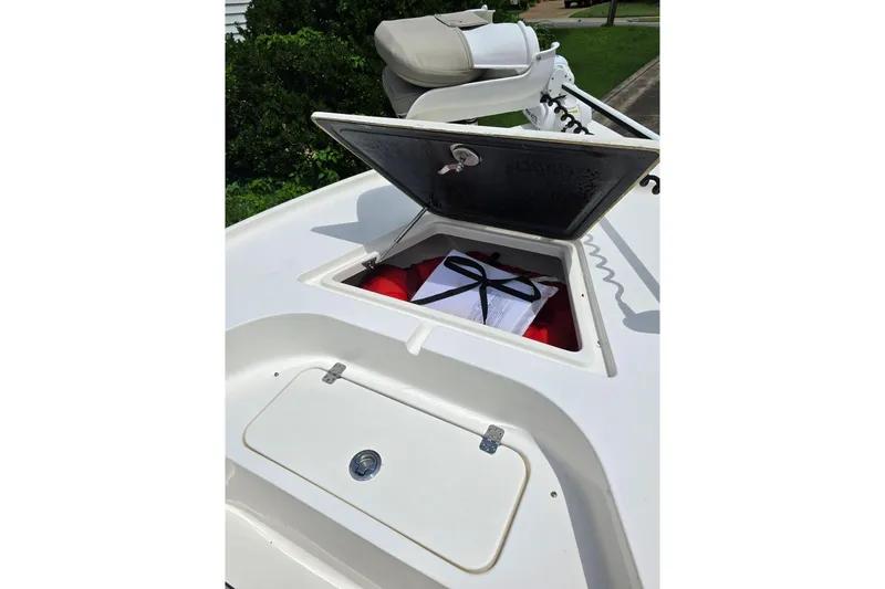Slide: The Image of 2023 Key West 188 Bay Reef boat with open storage compartment, revealing life jackets. - 27