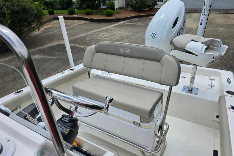 Slide: The Image of 2023 Key West 188 Bay Reef boat interior with steering wheel and seating. - 28