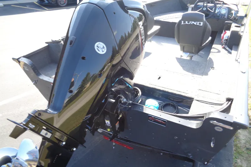 Slide: The Image of 2026 Lund 1650 Rebel XL SS boat with powerful outboard motor and spacious interior. - 15