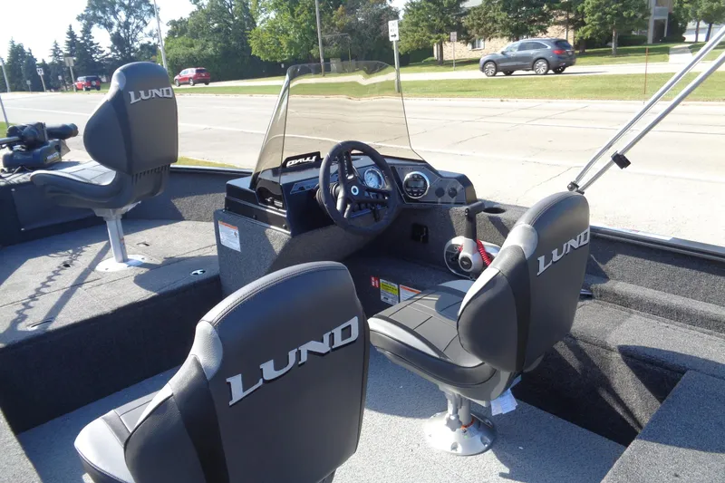 Slide: The Image of 2026 Lund 1650 Rebel XL SS boat interior with steering console and seating. - 17
