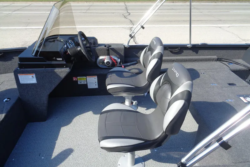 Slide: The Image of 2026 Lund 1650 Rebel XL SS boat interior with steering console and two seats. - 23