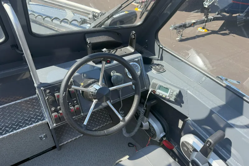 Slide: The Image of 2021 Hewescraft 210 Sea Runner ET boat cockpit with steering wheel and control panel. - 10