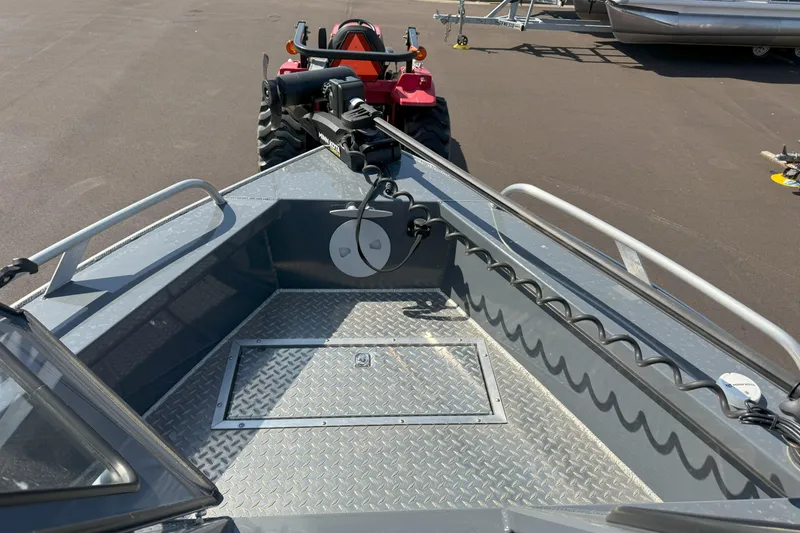 Slide: The Image of 2021 Hewescraft 210 Sea Runner ET boat with diamond plate flooring and mounted equipment. - 13