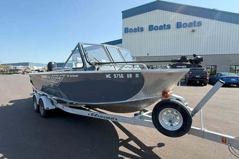 Slide: The Image of 2021 Hewescraft 210 Sea Runner ET boat on trailer outside dealership. - 2