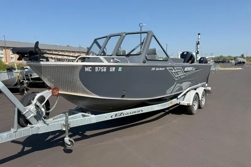 Slide: The Image of 2021 Hewescraft 210 Sea Runner ET boat on trailer in parking lot. - 3