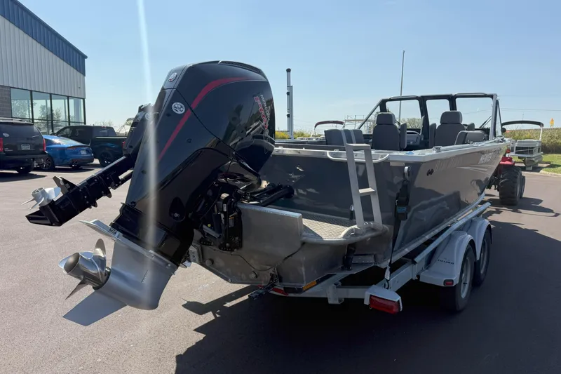 Slide: The Image of 2021 Hewescraft 210 Sea Runner ET boat on trailer, featuring powerful outboard motor. - 4