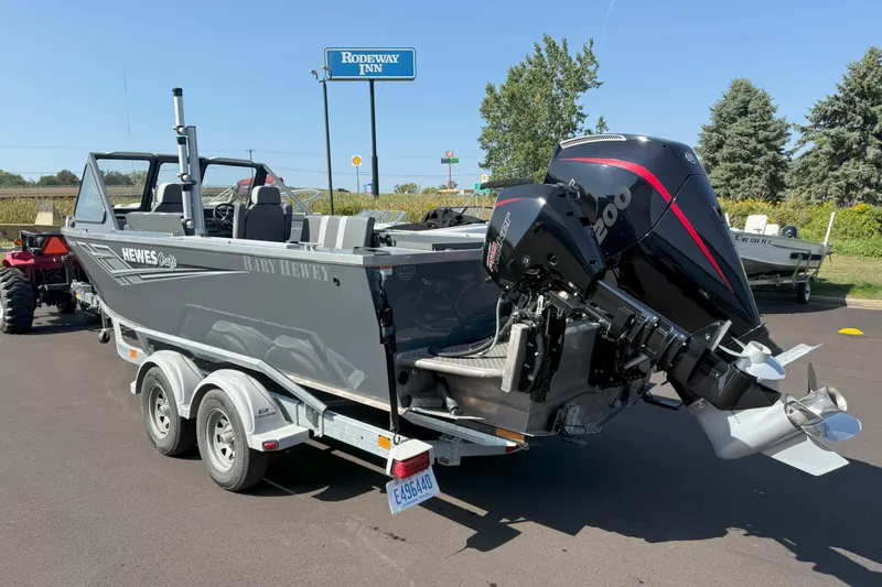 Slide: The Image of 2021 Hewescraft 210 Sea Runner ET boat on trailer, parked near Rodeway Inn. - 5