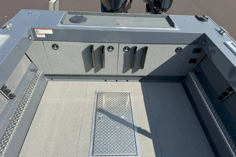 Slide: The Image of 2021 Hewescraft 210 Sea Runner ET boat interior with storage compartments and rod holders. - 6