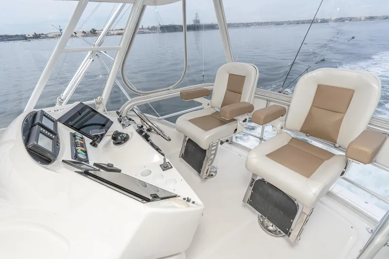 Slide: The Image of 2009 Riviera 47 Open Flybridge Series II helm with dual captain chairs on open water. - 10