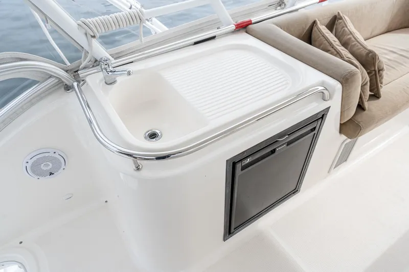 Slide: The Image of 2009 Riviera 47 Open Flybridge Series II yacht interior with sink and seating area. - 16