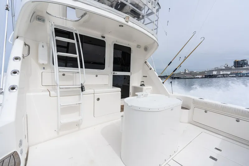 Slide: The Image of 2009 Riviera 47 Open Flybridge Series II yacht deck with ladder and ocean view. - 18