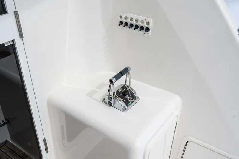Slide: The Image of 2009 Riviera 47 Open Flybridge Series II yacht control panel with throttle levers. - 29