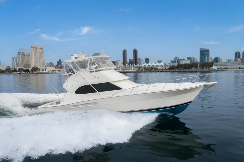 Slide: The Image of 2009 Riviera 47 Open Flybridge Series II cruising near city skyline. - 3