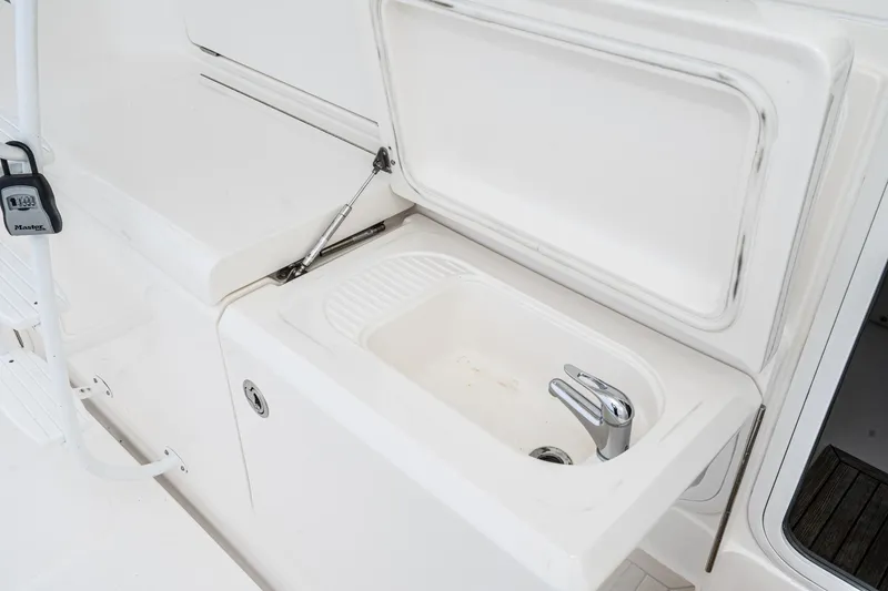 Slide: The Image of Riviera 47 Open Flybridge Series II 2009 boat sink with open lid and faucet. - 32