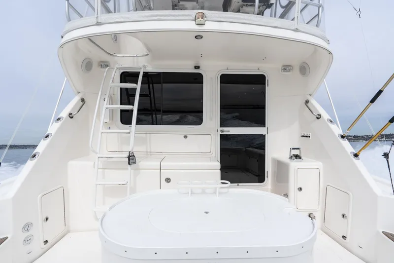 Slide: The Image of 2009 Riviera 47 Open Flybridge Series II yacht, rear view with ladder and seating area. - 35
