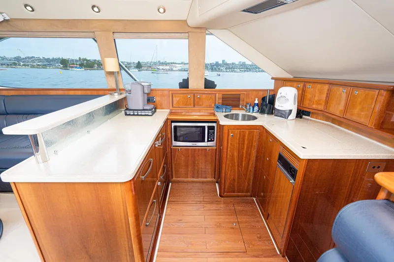 Slide: The Image of Luxurious 2009 Riviera 47 yacht kitchen with wood cabinetry and modern appliances. - 42
