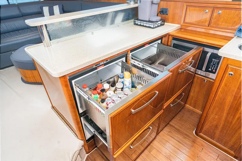 Slide: The Image of 2009 Riviera 47 Open Flybridge Series II yacht kitchen with open drawers and modern appliances. - 43