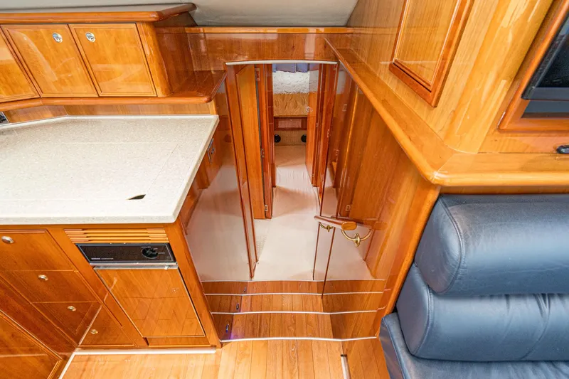 Slide: The Image of Luxurious interior of 2009 Riviera 47 Open Flybridge Series II yacht with polished wood finishes. - 44