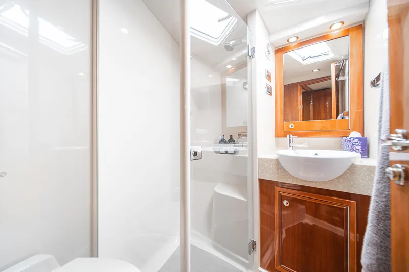 Slide: The Image of Luxurious bathroom in 2009 Riviera 47 Open Flybridge Series II yacht, featuring modern fixtures. - 48