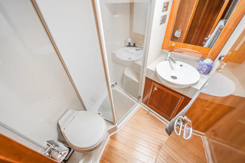 Slide: The Image of Luxurious bathroom in 2009 Riviera 47 Open Flybridge Series II yacht, featuring modern fixtures. - 49