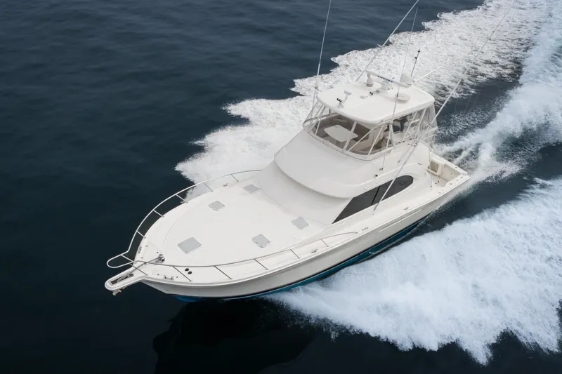 Slide: The Image of 2009 Riviera 47 Open Flybridge Series II yacht cruising on open water. - 5