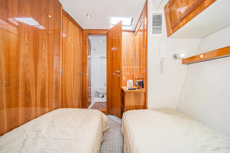 Slide: The Image of Interior of 2009 Riviera 47 Open Flybridge Series II yacht cabin with twin beds. - 51