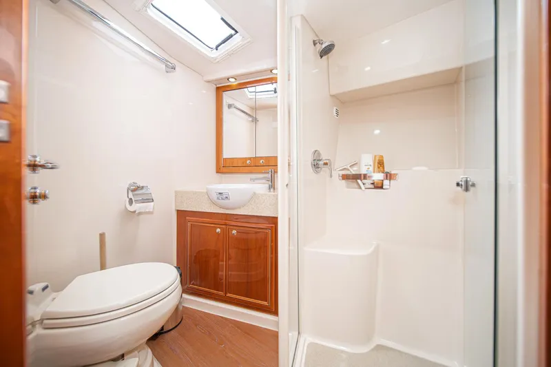 Slide: The Image of Luxurious bathroom in 2009 Riviera 47 Open Flybridge Series II yacht, featuring shower and vanity. - 52