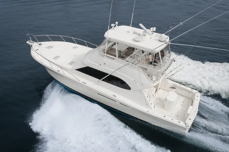 Slide: The Image of 2009 Riviera 47 Open Flybridge Series II yacht cruising on open water. - 6