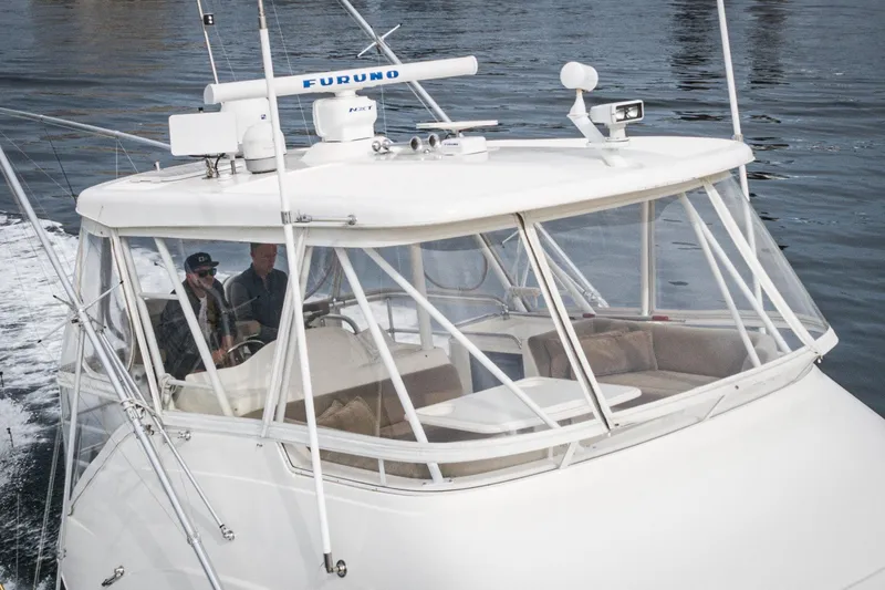 Slide: The Image of 2009 Riviera 47 Open Flybridge Series II cruising on water, featuring spacious cockpit. - 7