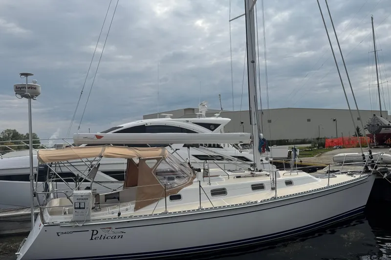 The Image of 2007 Tartan 3400 sailboat docked at marina under cloudy sky. - 0