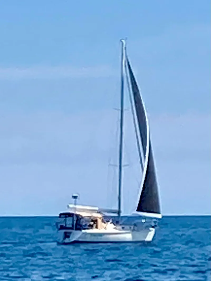 Slide: The Image of Sailboat Tartan 3400 (2007) gliding on open sea under clear blue sky. - 10