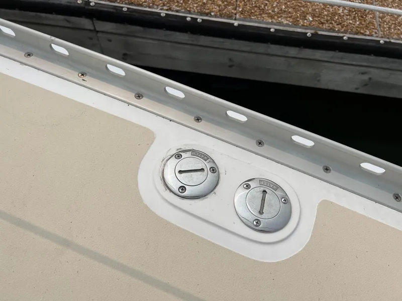 Slide: The Image of Fuel and water caps on a 2007 Tartan 3400 boat deck. - 18