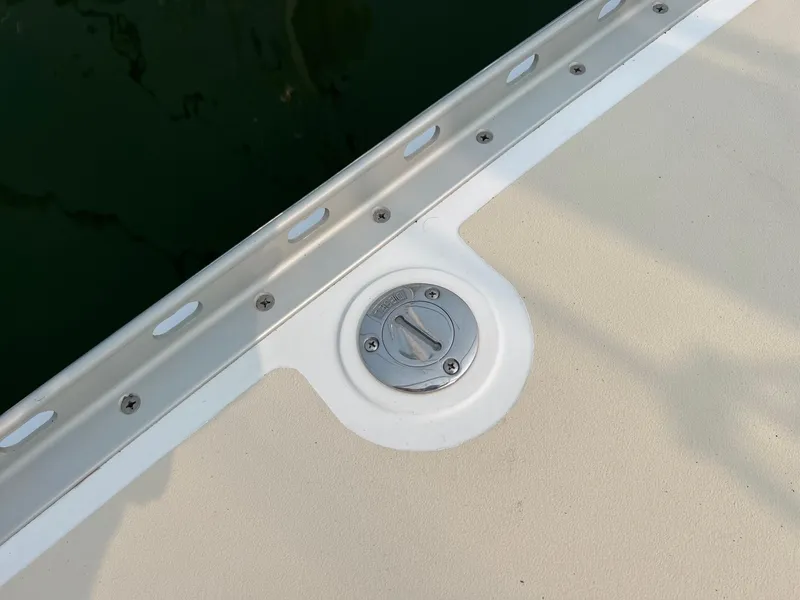 Slide: The Image of Deck detail of a 2007 Tartan 3400 sailboat, featuring a metal fitting. - 19