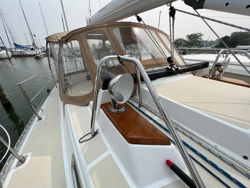 Slide: The Image of 2007 Tartan 3400 sailboat with beige canopy, docked in a marina. - 20