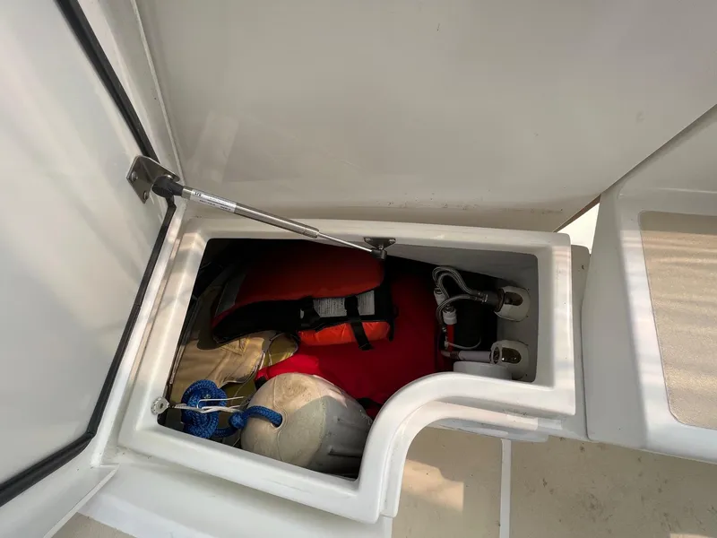 Slide: The Image of Storage compartment in a 2007 Tartan 3400 boat with safety gear and equipment. - 34